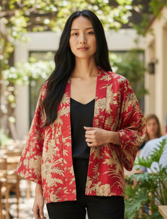 Model wearing a red kimono jacket with cream flowers