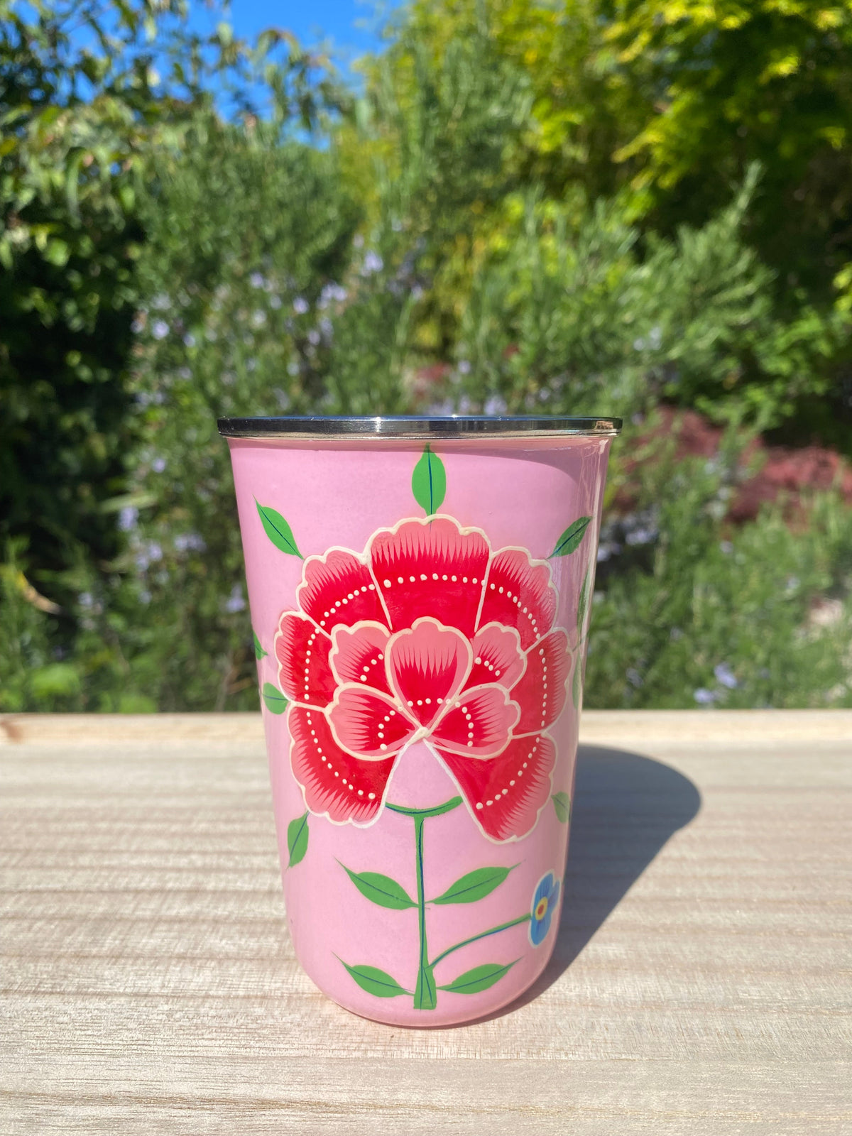 pale pink tumbler with red flower.  Enamel outer and stainless steel inside