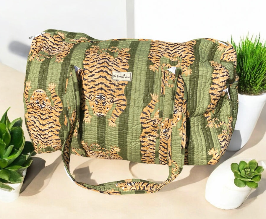 Green bag with tiger pattern on a white surface with plants