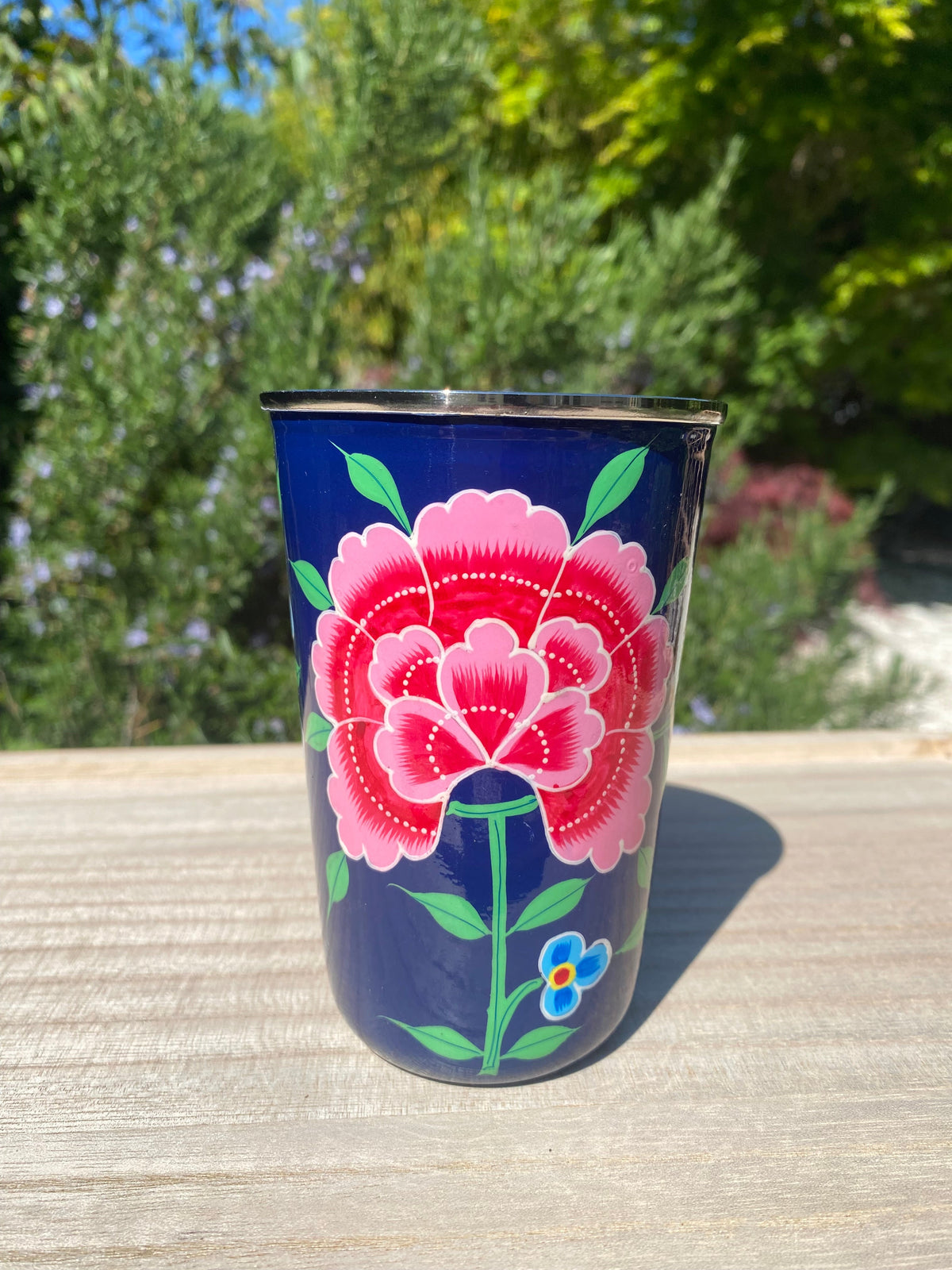 Dark blue tumbler with red flower.  Enamel outer and stainless steel inside