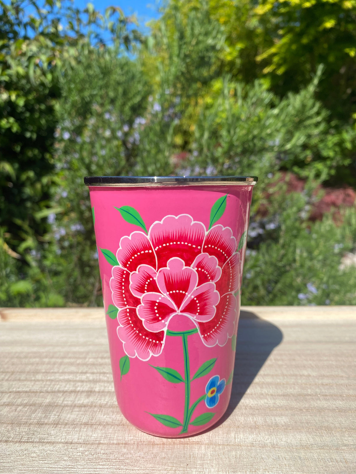 Bright pink tumbler with red flower.  Enamel outer and stainless steel inside