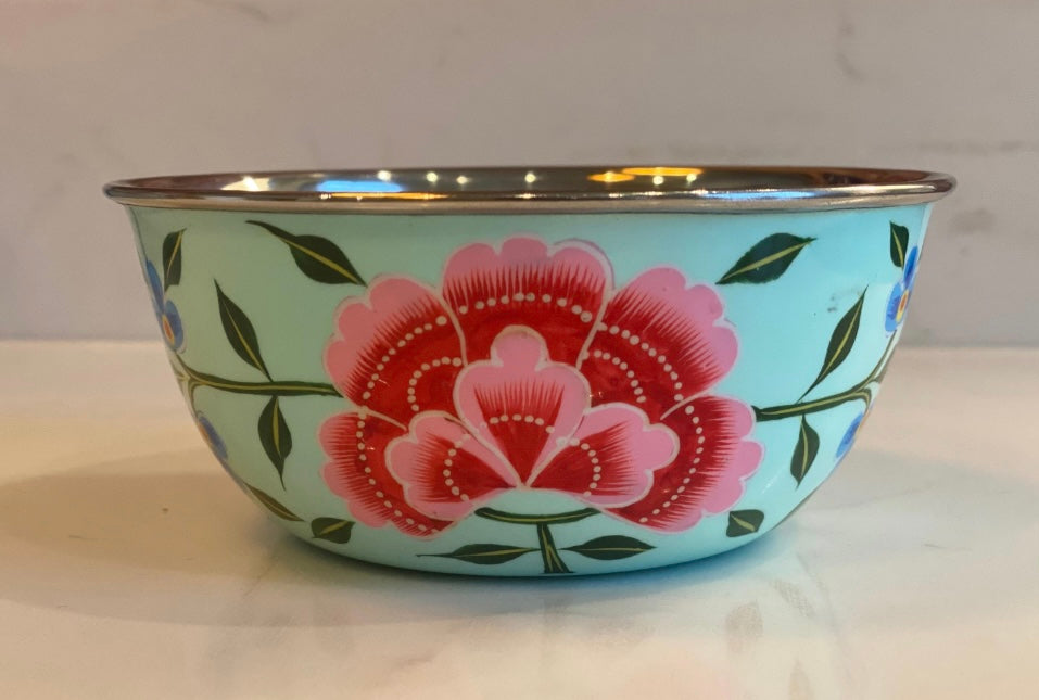Decorative bowl with pink floral design on a light blue background