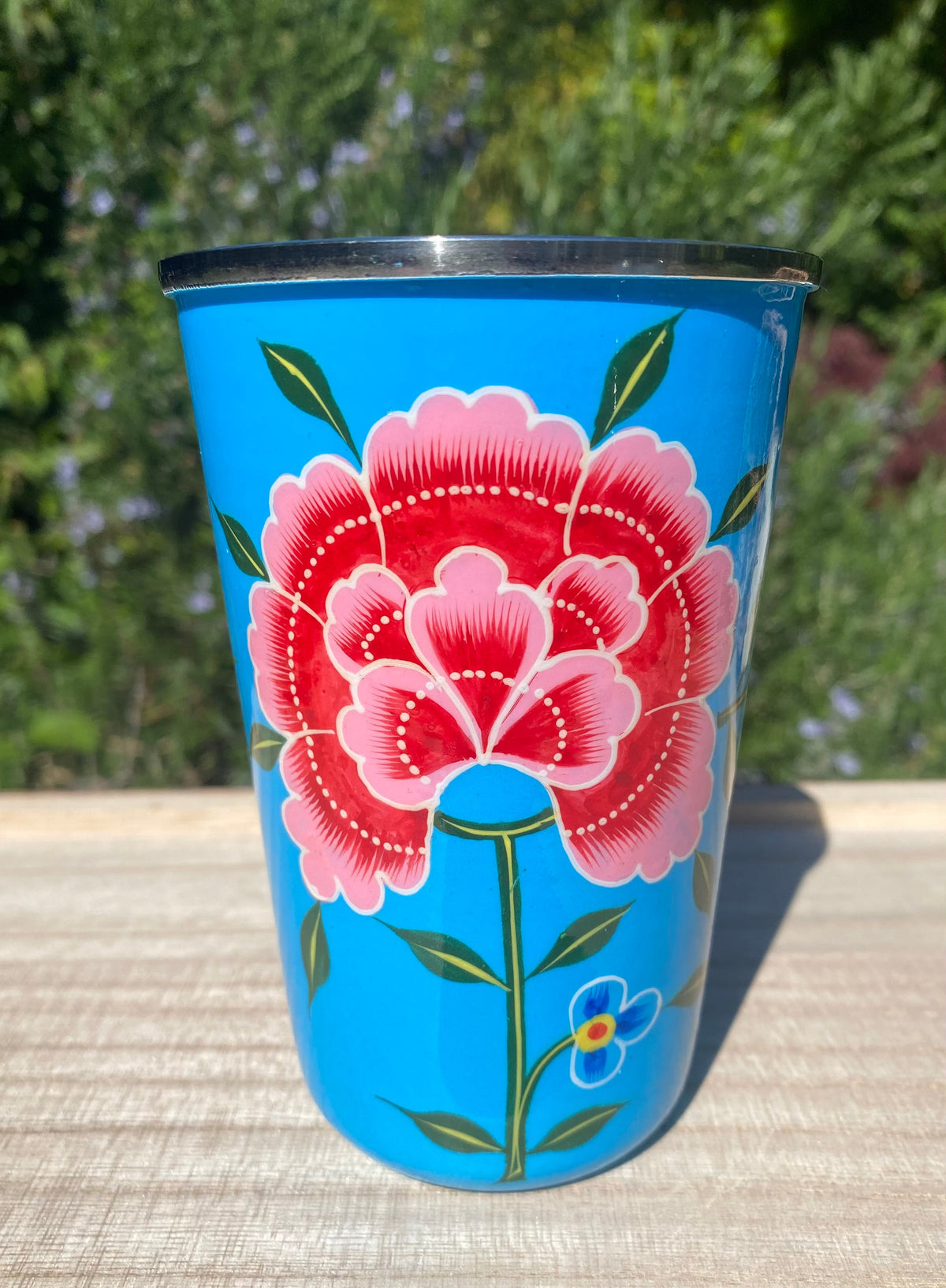 blue tumbler with red flower.  Enamel outer and stainless steel inside