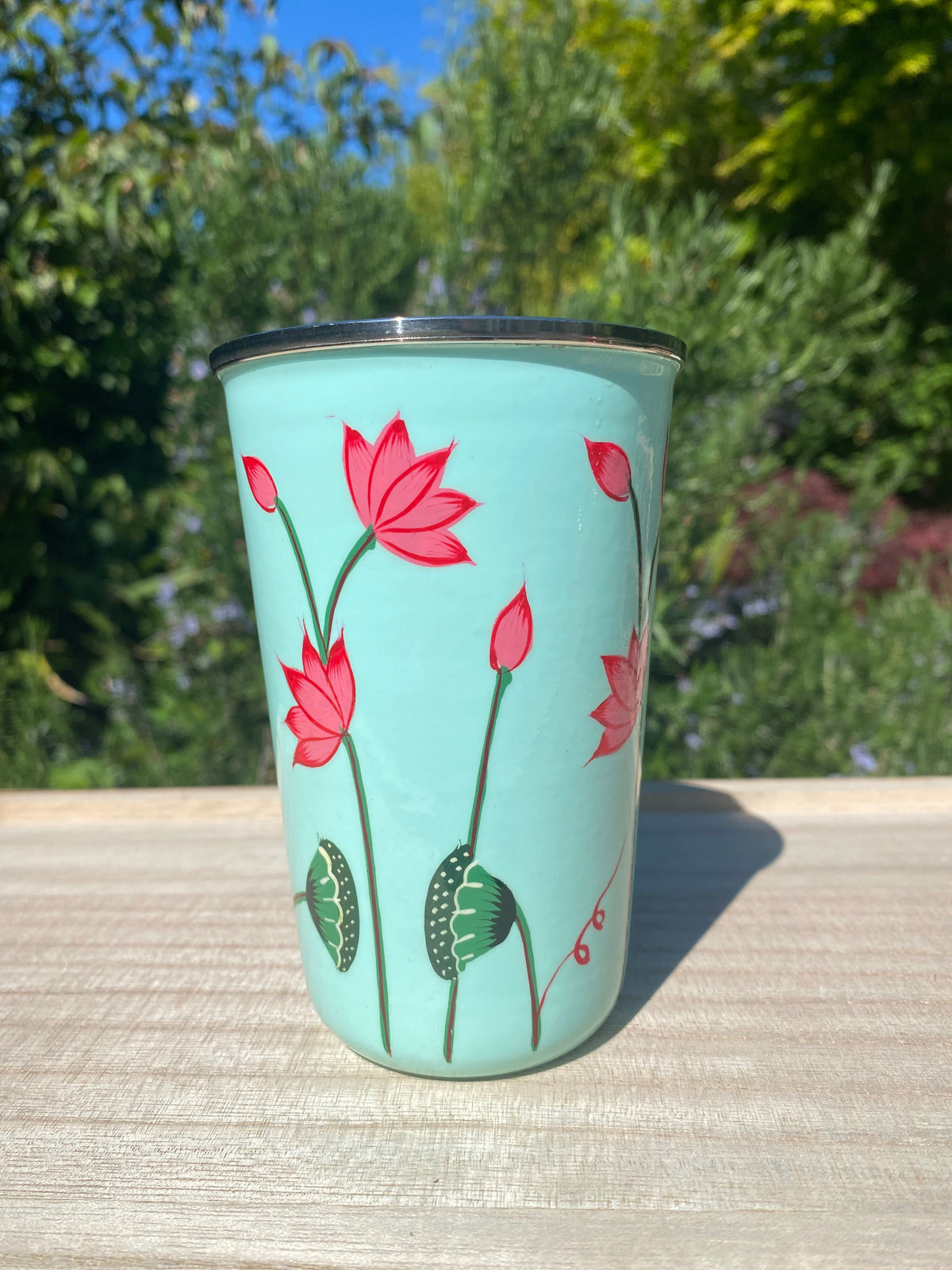 pale green  tumbler with lotus flower.  Enamel outer and stainless steel inside