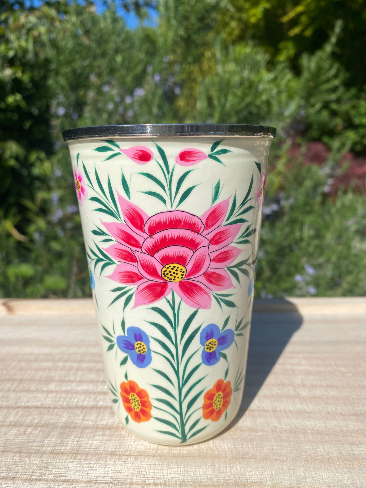 cream tumbler with red flower.  Enamel outer and stainless steel inside