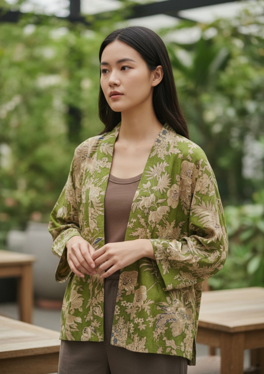 Olive green kimono jacket on model with cream flowers
