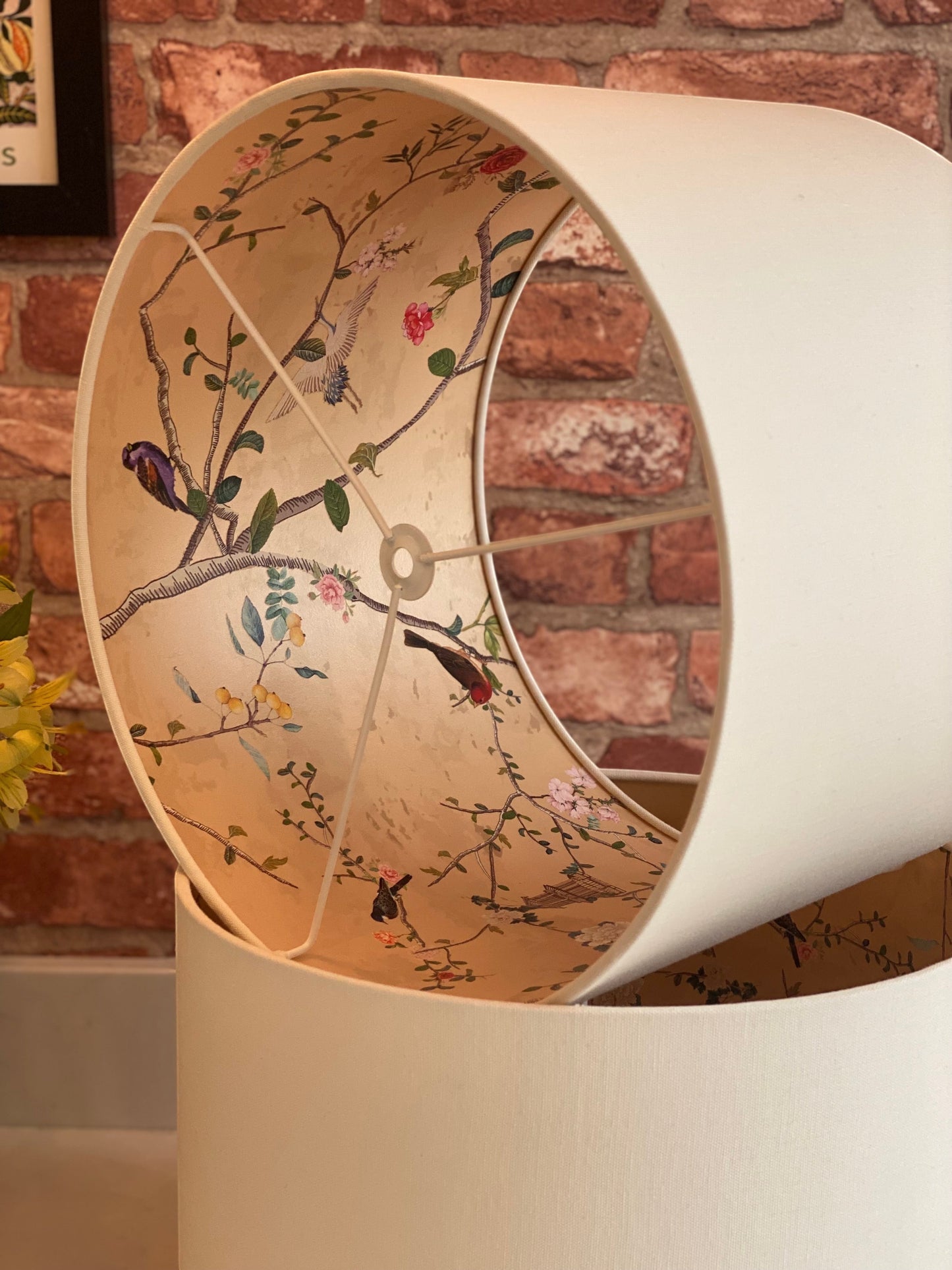 The Bamboo Bird handmade cream linen drum lampshade with an intricate gold chinoiserie bird and botanical lining
