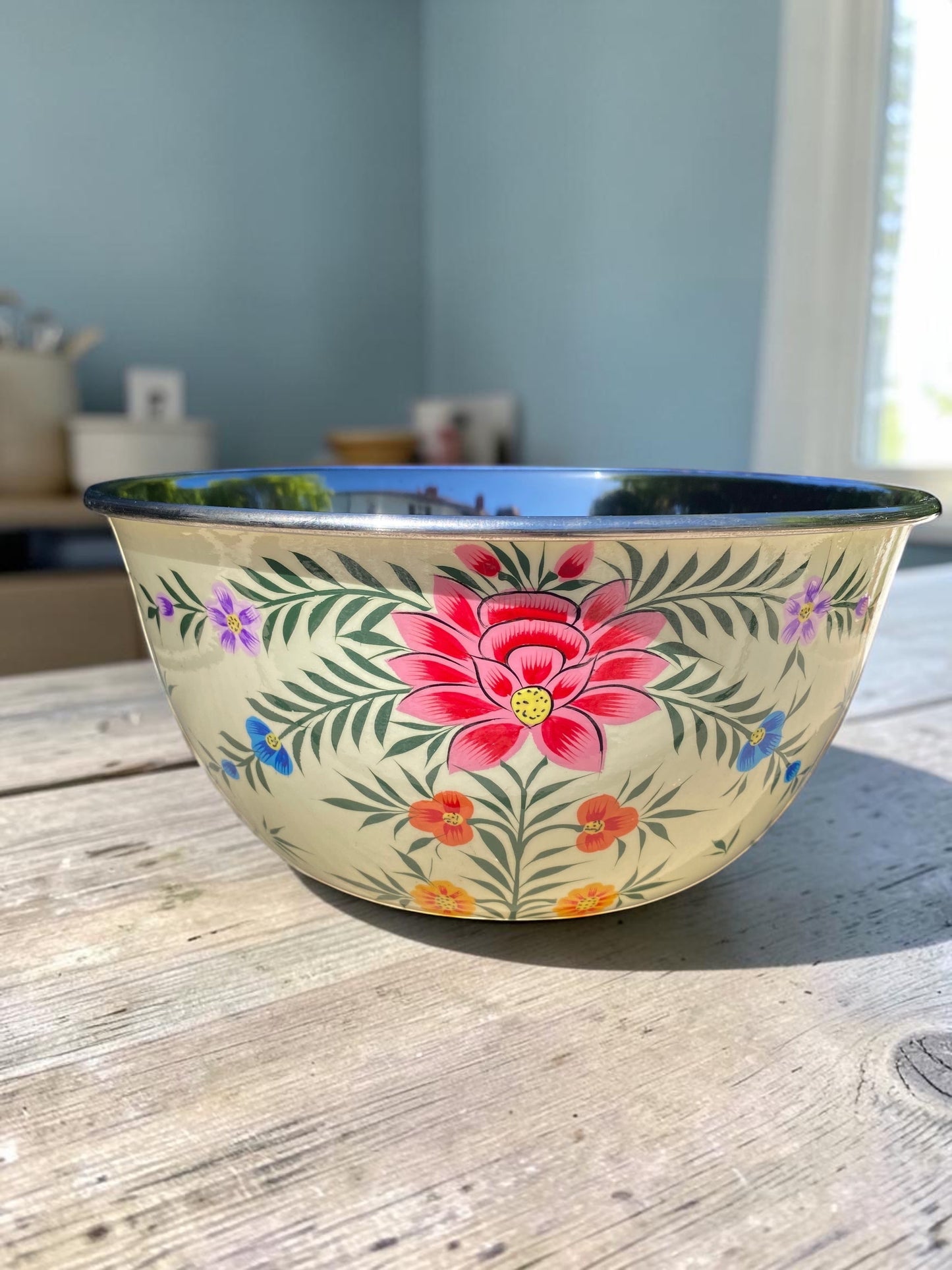 The Bamboo Bird hand-painted stainless steel and enamel bowl with floral patterns on a cream background