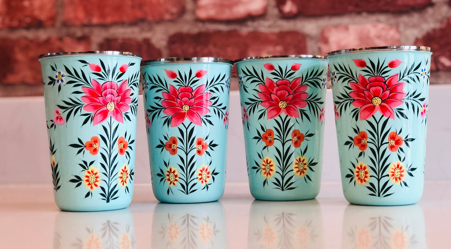 The Bamboo Bird set of four light blue stainless steel tumblers featuring hand-painted floral designs from Kashmir